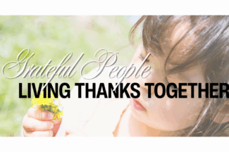Grateful People: Living Thanks Together. A young child inspects a dandelion in her hand.