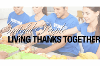 Grateful People: Living Thanks Together. Four young people wearing shirts that say "Volunteer" serve food in a cafeteria-style line.